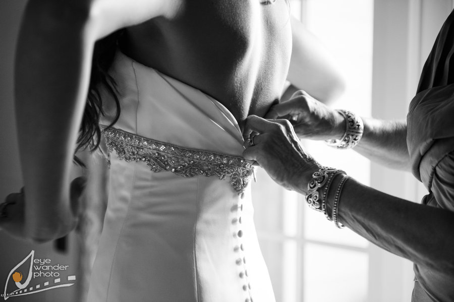 Bride putting on her wedding dress