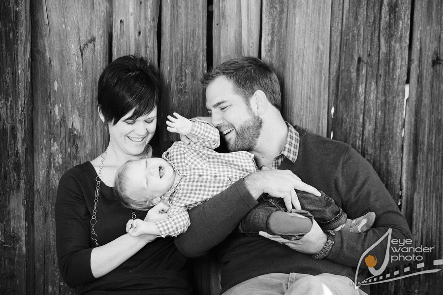 parents laughing with one year old