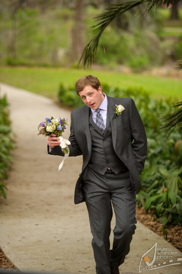 New Orleans Wedding Groom carries Bouquet and Silly Face