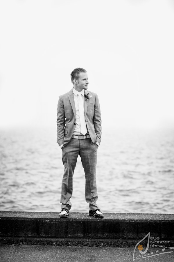 Mandeville New Orleans Wedding Groom Stands on Ledge Lake Pontchartrain 