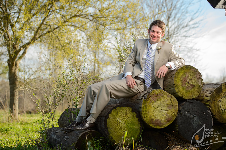 Baton Rouge Wedding Groom Sits on Old Moss Covered Oak Rounds