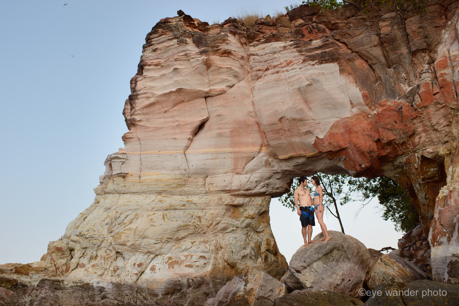 Thailand Secret Beach couple standing on beach under arch rock Thailand Secret Beach couple standing on beach under arch rock