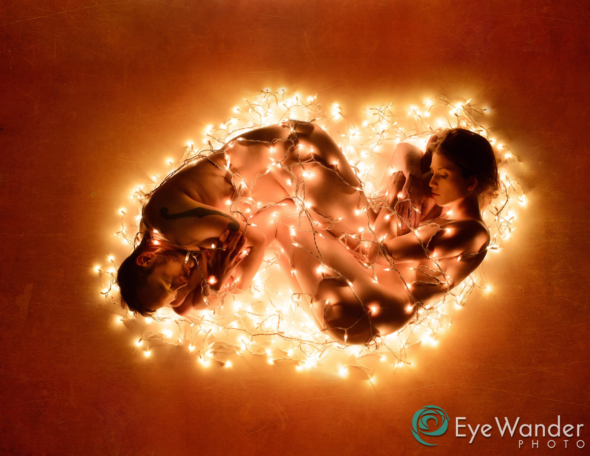 art nude couple wrapped in christmas lights